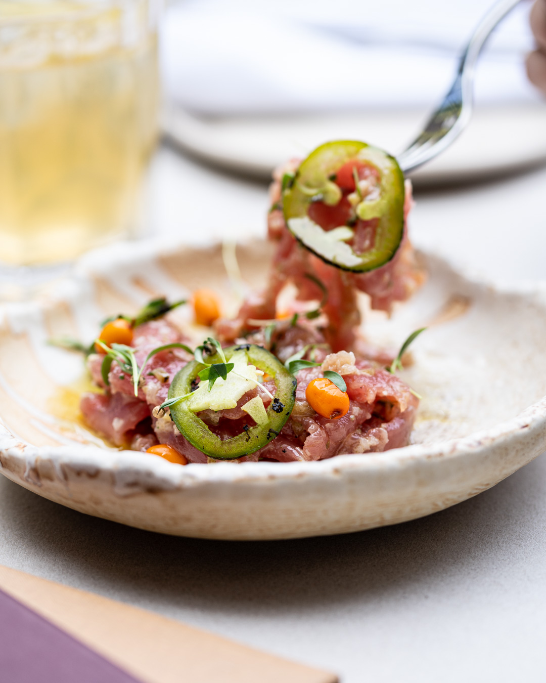 Close up of tuna sashimi with sea buckthorn and charred jalapeño at Drift Restaurant Halifax
